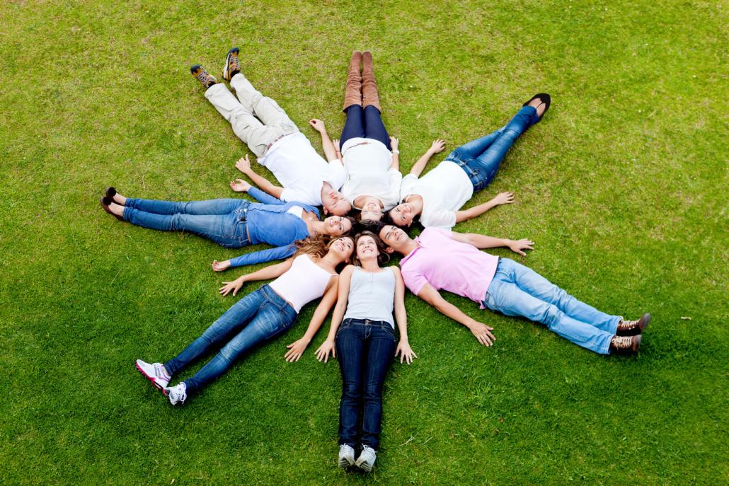 A group of people are laying in the grass